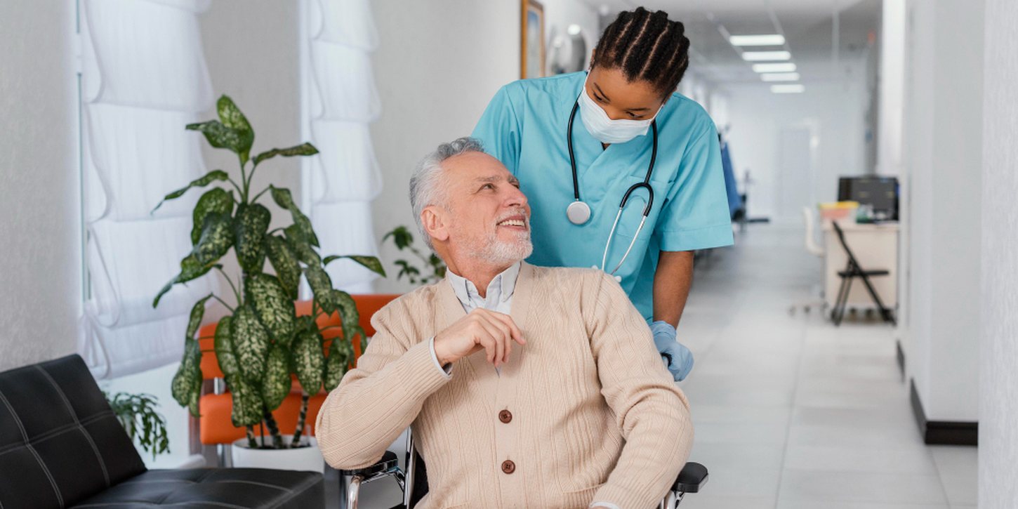 A nurse accompanying a client in a wheelchair