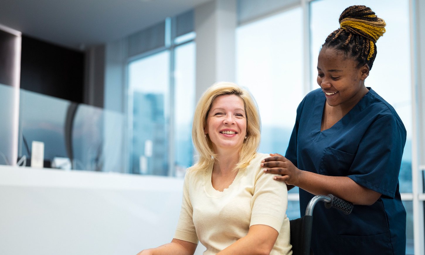 A caregiver greeting a client warmly at home