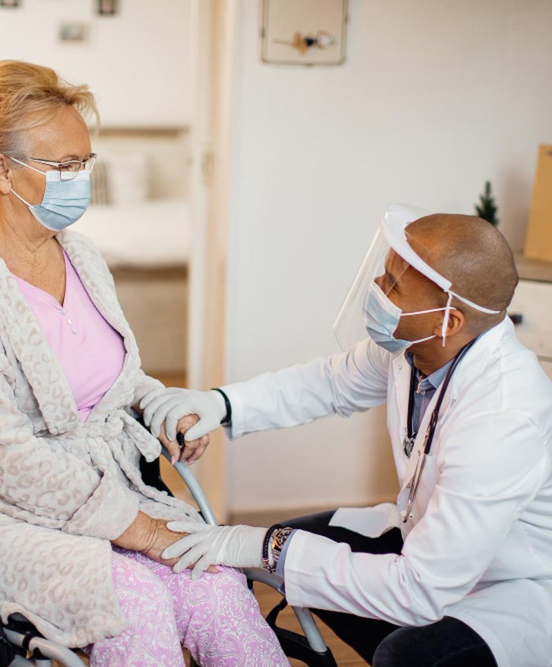 A clinician carrying out an assessment with a client in a wheelchair